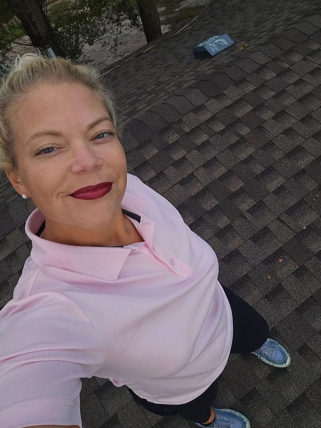 Rebekah Nicholson, owner of B & R Restoration, on a shingle roof job site